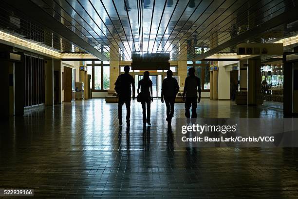 students in hallway - woman walking out door silhouette stock pictures, royalty-free photos & images