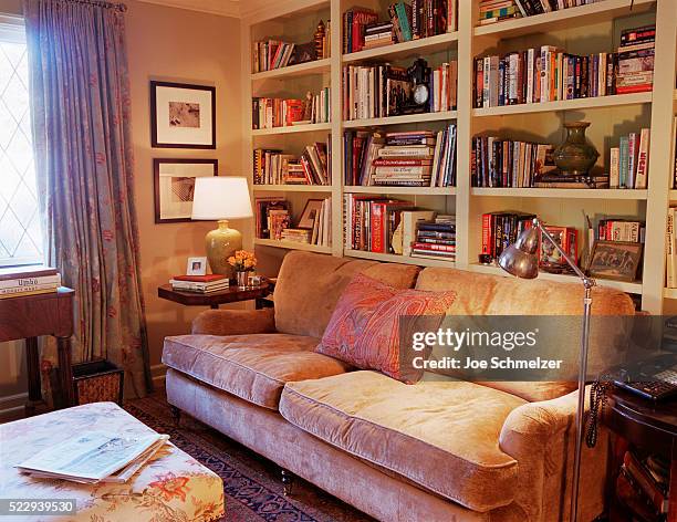built-in bookcases in home library - book on side table stock pictures, royalty-free photos & images