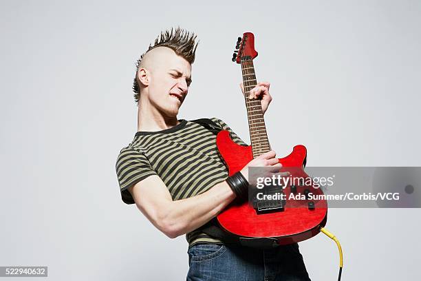 young man playing guitar - coiffure punk stock-fotos und bilder