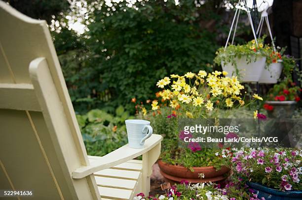 coffee cup on arm of adirondack chair - adirondack chair closeup stock pictures, royalty-free photos & images