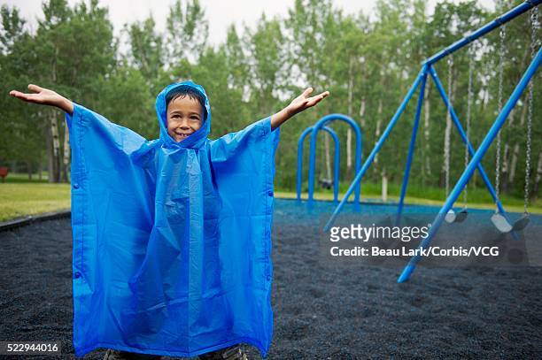 girl on a rainy playground - caught in rain stock pictures, royalty-free photos & images