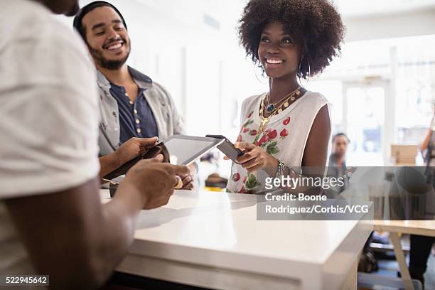 woman paying for lunch - chubby man shopping stock pictures, royalty-free photos & images