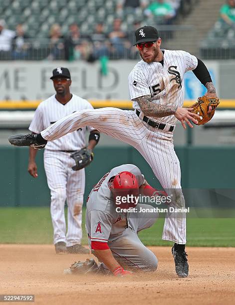 Brett Lawrie of the Chicago White Sox leaps over Mike Trout of the Los Angeles Angels to turn a double play in the 8th inning at U.S. Cellular Field...