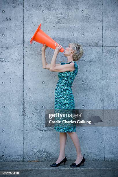 woman using traffic cone as a megaphone - cone loudspeaker stock pictures, royalty-free photos & images
