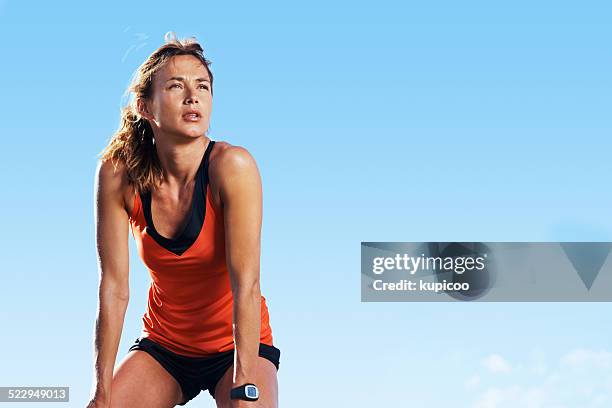 taking a break from running - woman standing exercise stockfoto's en -beelden