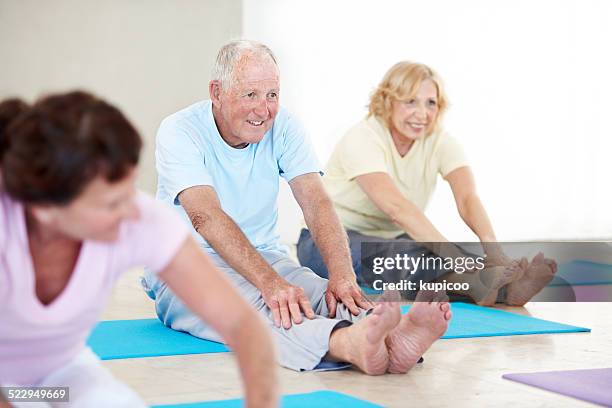 staying fit and active - touching toes stock pictures, royalty-free photos & images