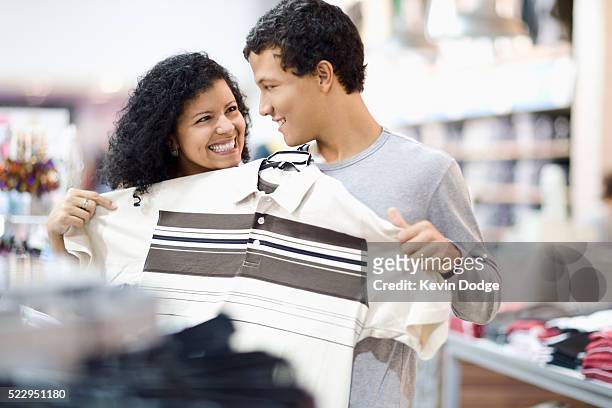 mother and son shopping for clothing - teenager boy shopping stock-fotos und bilder