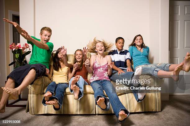 group of teenagers on the couch - teen girl barefoot at home stock pictures, royalty-free photos & images