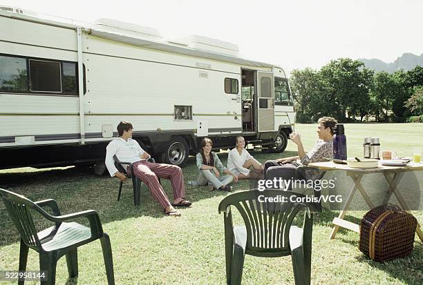 campers sitting next to motor home - archival camping stock pictures, royalty-free photos & images