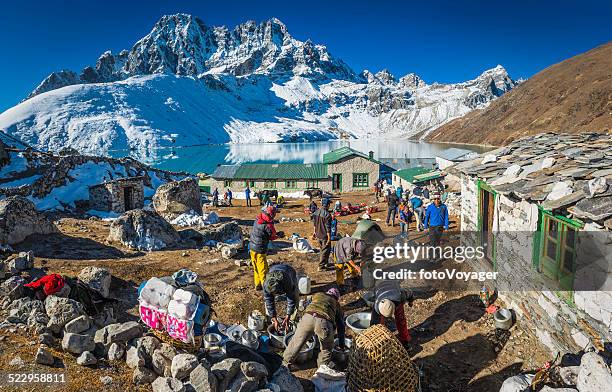 expedition team breaking camp sherpa teahouses gokyo himalaya mountains nepal - gokyo valley stock pictures, royalty-free photos & images