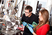 Scientists working with laser deposition chamber