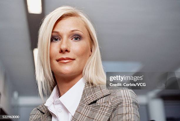 blond businesswoman at the office - lapel stock-fotos und bilder