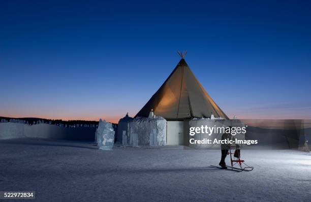 woman using kick sled at icehotel - ice hotel sweden stock pictures, royalty-free photos & images