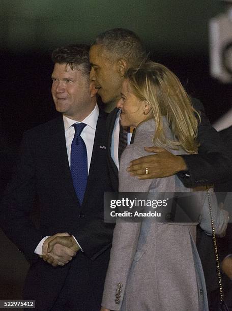 President Barack Obama is greeted by US ambassador Matthew Barzun and his spouse Brooke Brown after he left US presidential plane Air Force One as it...