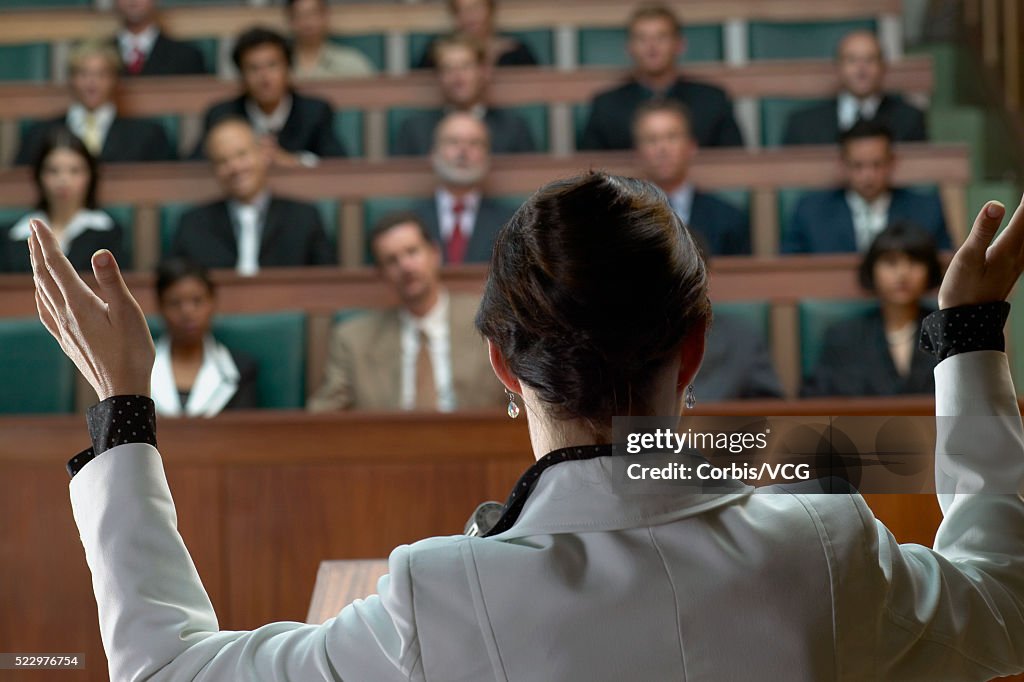 A woman giving a speech in front of an audience