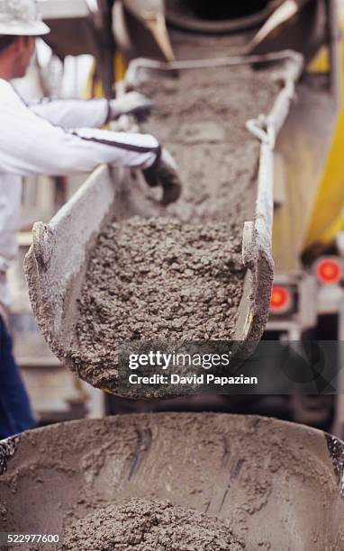 liquid concrete is poured for the foundation of a high-rise building under construction - building foundations stock-fotos und bilder