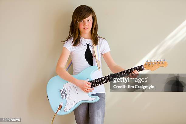 pre-teen girl playing guitar - jim craigmyle guitar stock pictures, royalty-free photos & images