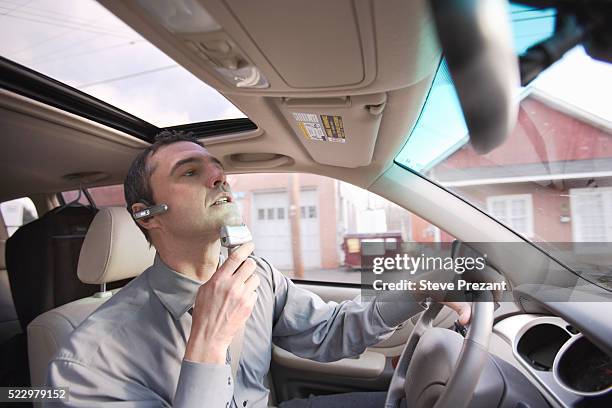 businessman shaving while driving - scheren stockfoto's en -beelden
