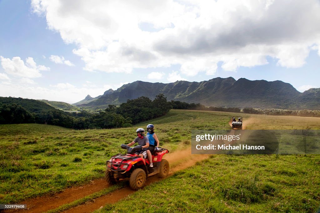 People exploring on all-terrain vehicle