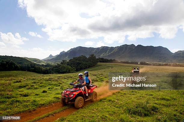 people exploring on all-terrain vehicle - kauai stock pictures, royalty-free photos & images