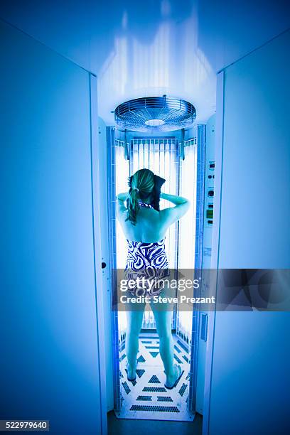 woman in a tanning booth - tanning bed stock pictures, royalty-free photos & images