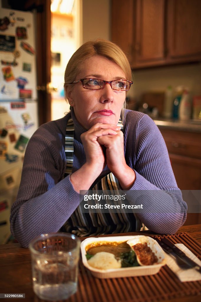 Woman Sitting at Kitchen Table