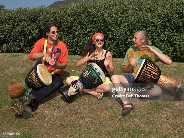 three drummers in a park - percussion instrument stock pictures, royalty-free photos & images