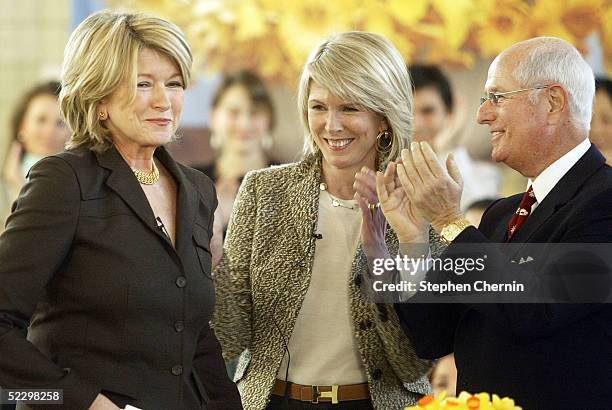 Martha Stewart smiles as she is applauded by Susan Lyne, President and CEO and Charles Koppleman, Vice-Chairman, both of Martha Stewart Living, prior...