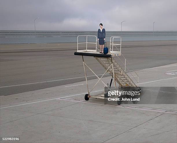 woman standing on gangway with no airplane - airplane gangway stock pictures, royalty-free photos & images