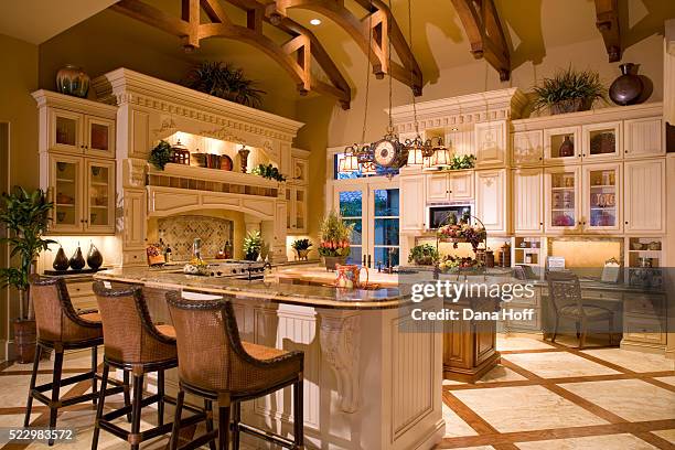 white cabinetry in traditional kitchen with wood and marble floor - sierlijst stockfoto's en -beelden