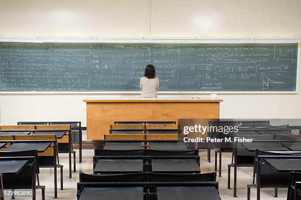 woman looking at blackboard - archival classroom stock pictures, royalty-free photos & images