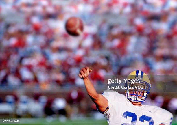 football quarterback in action - quarterback stock pictures, royalty-free photos & images