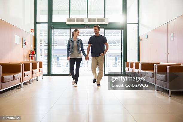 young couple entering hospital - entering hospital stock pictures, royalty-free photos & images