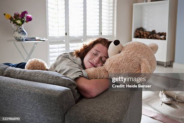man hugging teddy bear - teddy bear stock pictures, royalty-free photos & images