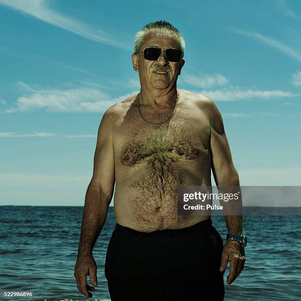 middle aged man at the beach. - fat man on beach stock pictures, royalty-free photos & images