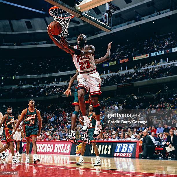 Michael Jordan of the Chicago Bulls goes for a layup against the Seattle Supersonics circa 1996 during the NBA game at Chicago Stadium in Chicago,...