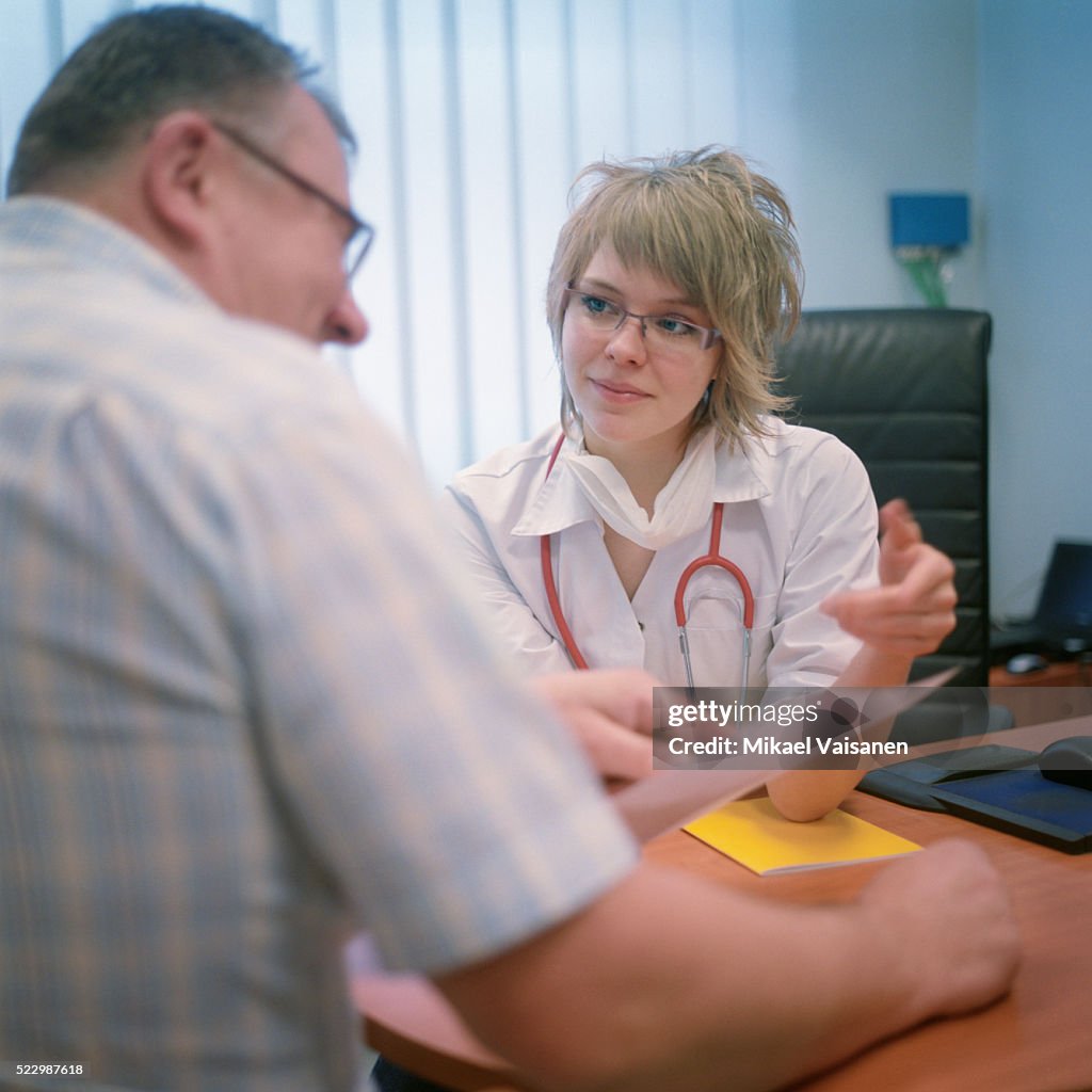 Explaining Diagnoses Doctor Explaining Diagnosis To Patient High-Res Stock Photo - Getty Images