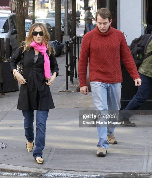 Husband and wife actors Matthew Broderick and Sarah Jessica Parker walk along the sidewak on March 7, 2005 in New York City.