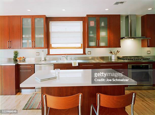 contemporary kitchen with wooden cabinets - steel furniture stock pictures, royalty-free photos & images