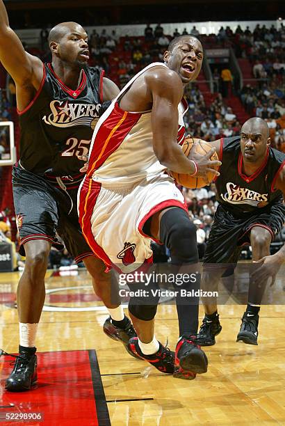 Dwyane Wade of the Miami Heat drives against Marc Jackson of the Philadelphia 76ers on March 7, 2005 at American Airlines Arena in Miami, Florida....