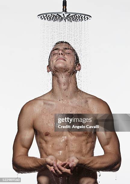 man taking shower - shower head stock pictures, royalty-free photos & images