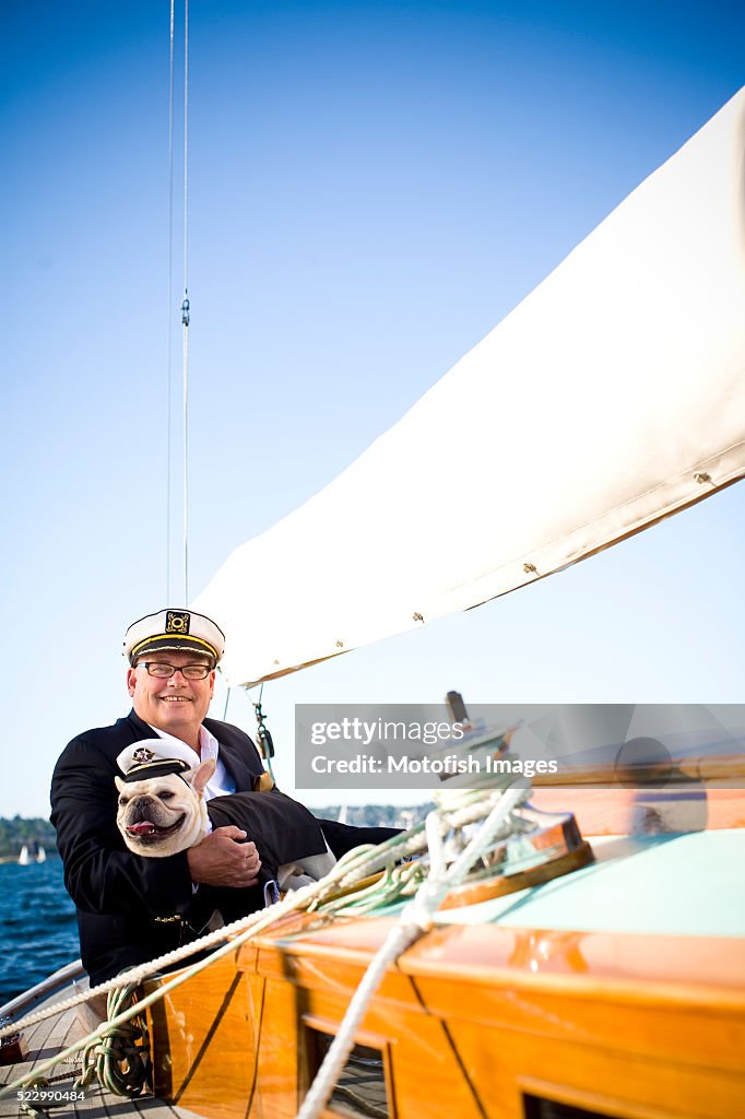 Senior Man Sailing with Dog