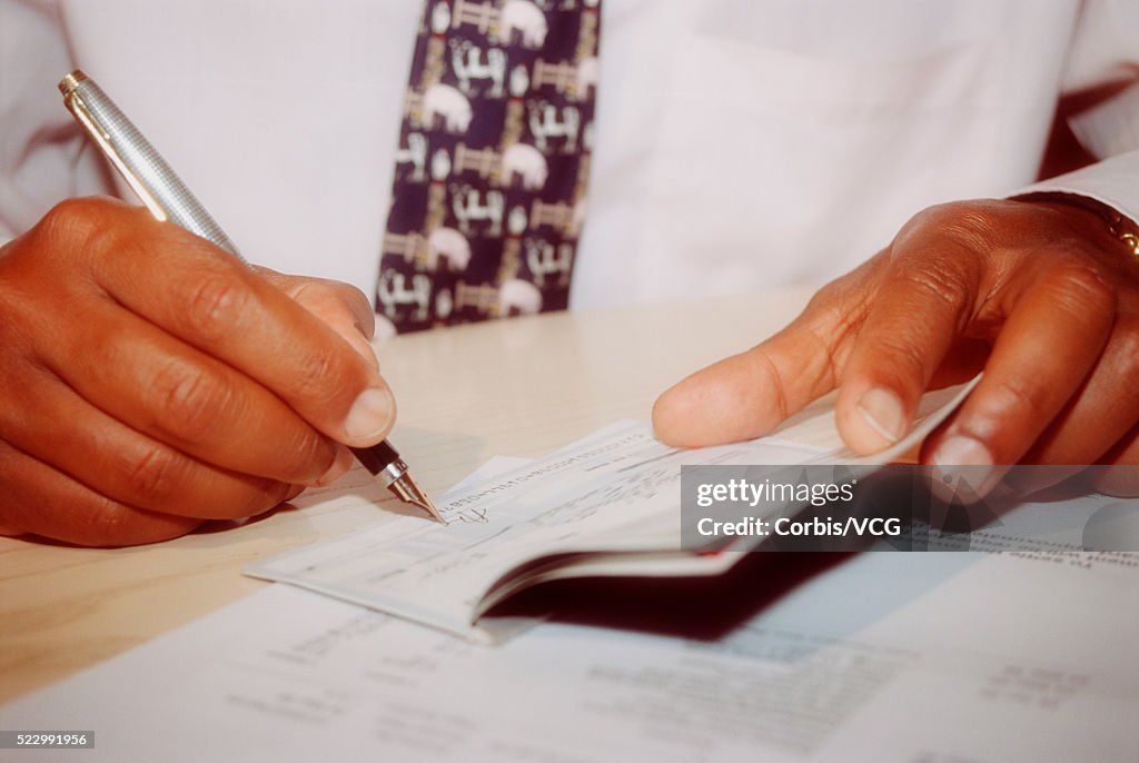 Businessman Signing A Check High-Res Stock Photo - Getty Images