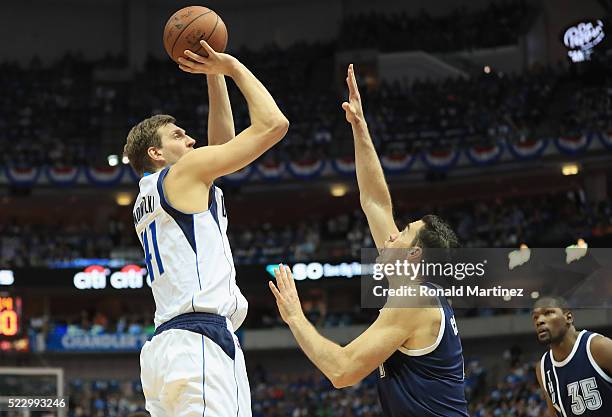 Dirk Nowitzki of the Dallas Mavericks takes a shot against Nick Collison of the Oklahoma City Thunder during game three of the Western Conference...