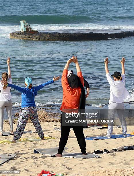 Libyan women take part in a seaside yoga session at a secluded beach in the Libyan capital Tripoli, on April 14, 2016. For many Libyan women who...