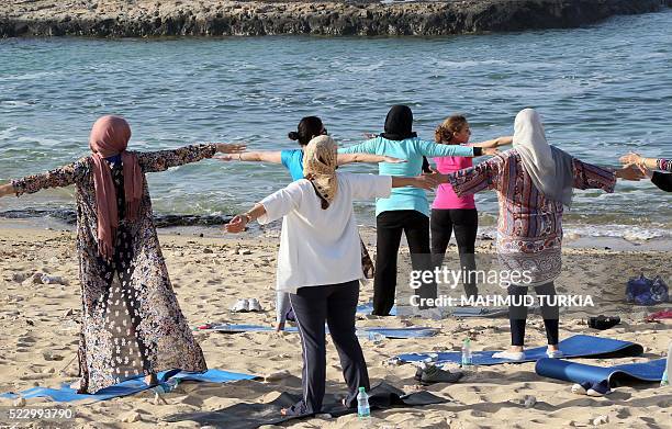 Libyan women take part in a seaside yoga session at a secluded beach in the Libyan capital Tripoli, on April 14, 2016. For many Libyan women who...