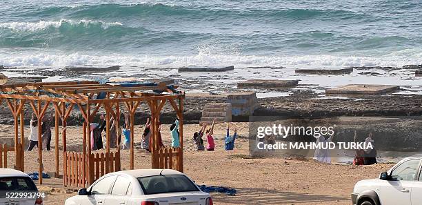 Libyan women take part in a seaside yoga session at a secluded beach in the Libyan capital Tripoli, on April 14, 2016. For many Libyan women who...