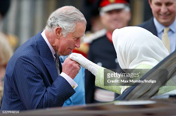 Prince Charles, Prince of Wales kisses Queen Elizabeth II's hand as they attend a beacon lighting ceremony to celebrate her 90th birthday on April...