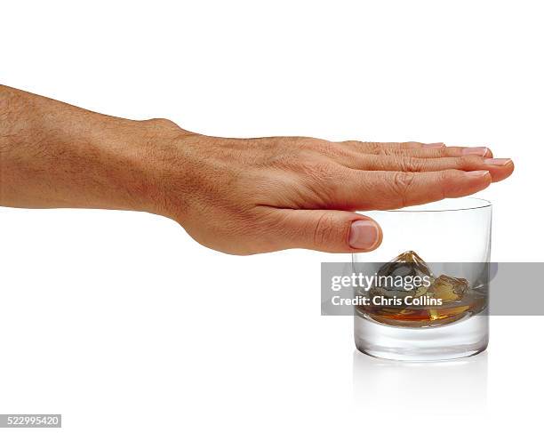 man covering whiskey glass with hand - alcohol abuse stock pictures, royalty-free photos & images