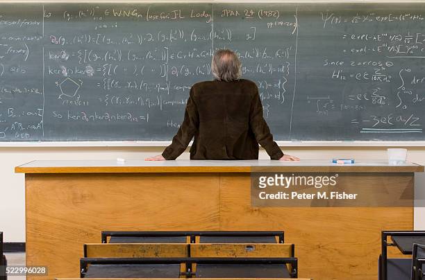 man looking at blackboard - lecturer stock pictures, royalty-free photos & images